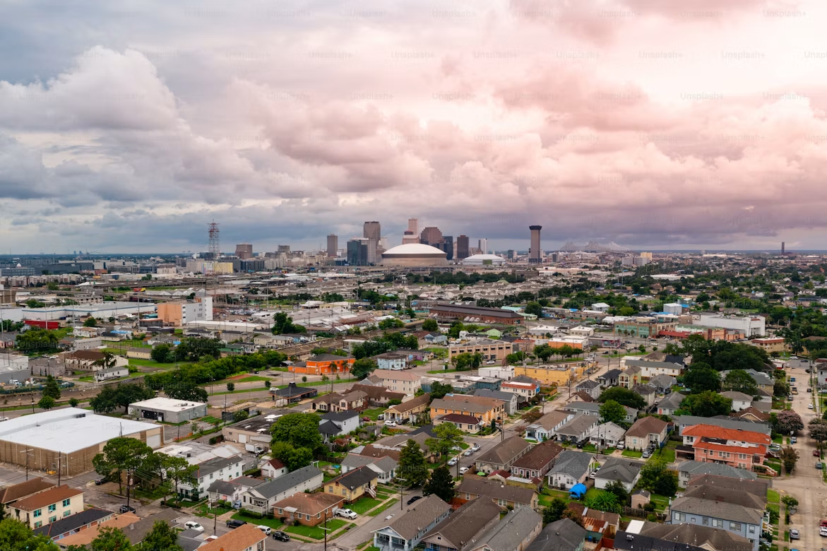 Aerial view of New Orleans neighborhoods and skyline.